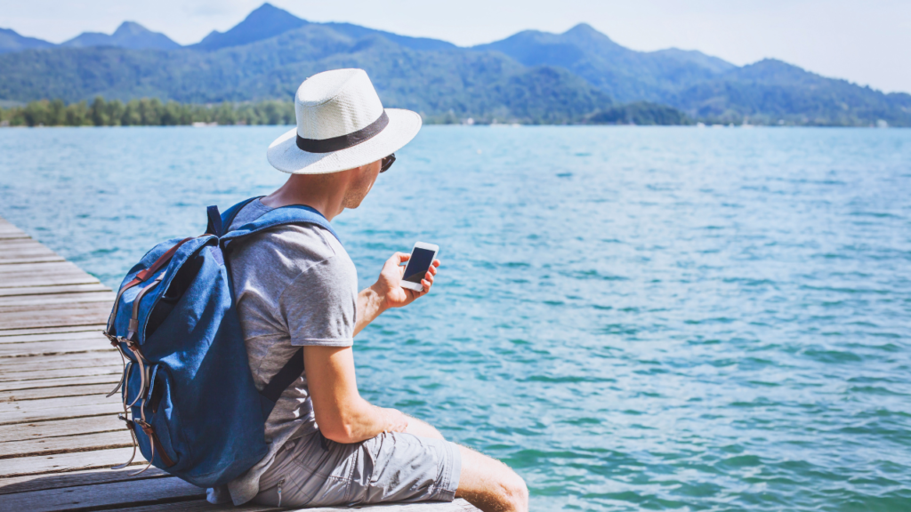 Tourist traveler using mobile phone, smartphone travel app.